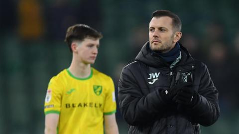 Jack Wilshire claps his hands as he leaves the pitch with Norwich players