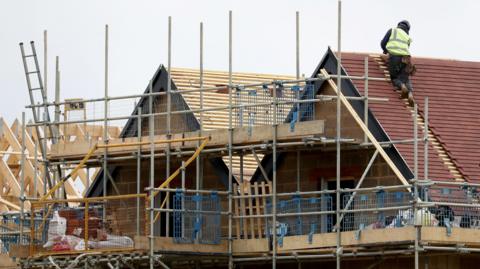 A builder working on a house