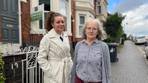 Local residents and campaigners Sassi Stark and Joan Dutton stand together on a Derby Street infront of a HMO with a To Let sign on the front