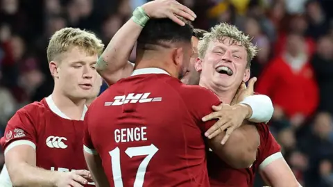 Jac Morgan celebrates scoring a try
