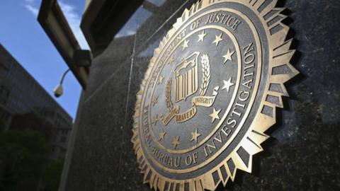 A picture of the FBI seal on the side of a building