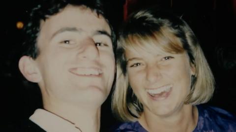 A film photograph of Tim Burman and Rosie Grant smiling. Tim has brown hair and Rosie has a blonde bob.