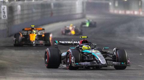 Mercedes' Lewis Hamilton is pictured in the foreground with a McLaren, Red Bull and Sauber behind him