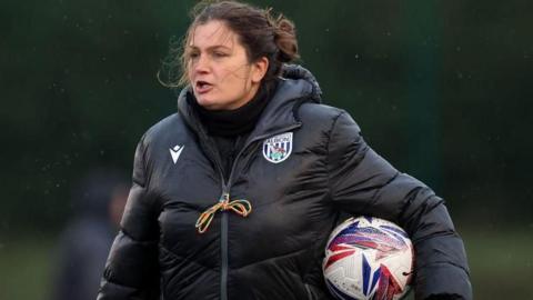  Siobhan Hodgetts-Still taking a training session with a football tucked under her arm