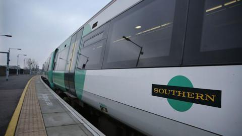 A Southern rail train stationed at a platform.