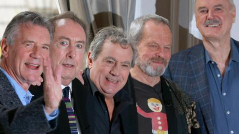 Members of Monty Python including Terry Jones smile at camera