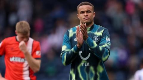 Carlton Morris applauds the Luton supporters