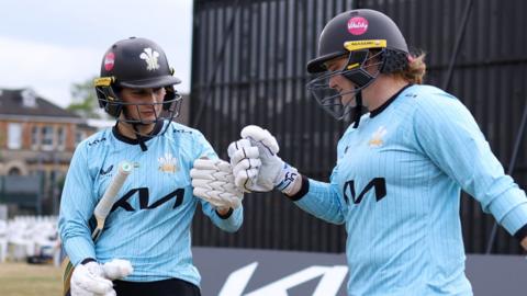 Kira Chathli and Bryony Smith of Surrey lead the team out to bat
