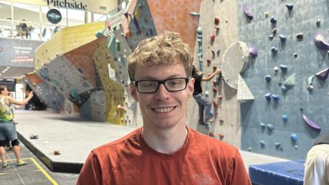 Matthew Phillips standing at Surrey Summit climbing 