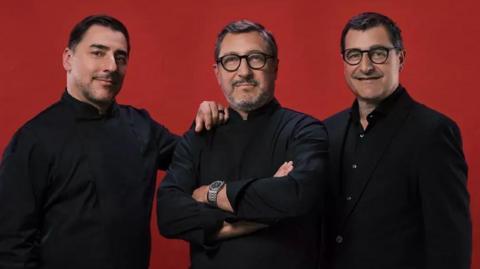 Joan, Josep and Jordi - all are dressed in black and looking into the camera, with a red backdrop behind them saying The MacAllan Timespirit name