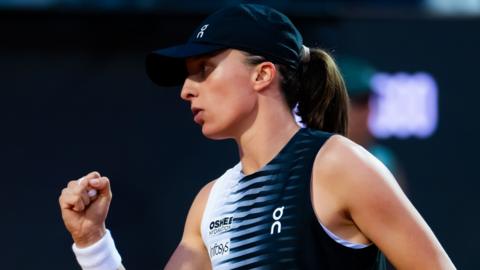 Iga Swiatek celebrates a point with a clenched fist during the Italian Open