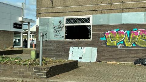 Graffiti and damage to empty shop units 