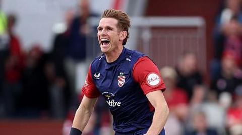 Kent bowler Fred Klaassen celebrates after taking a wicket.