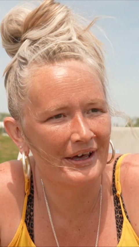 Woman with blonde hair in bikini top.