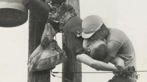 (Original Caption) 7/17/1967-Jacksonvill, Florida: Mouth-to mouth resuscitation is applied July 17th to power line worker Gilbert Champion (top), by co-worker J.D. Thompson. Champion was knocked unconscious when he brushed against a live wire. Seconds after the picture was taken, Thomspson shouted down, "He's breathing." Photographer Rocco Morabito BPA2#3163 