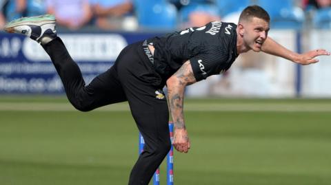 Conor McKerr bowling for Surrey last season