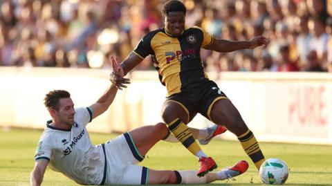 Bobby Kamwa of Newport County is challenged by Ryan Leonard of Millwall