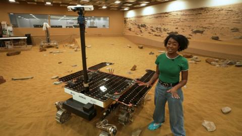 Emma-Louise stood next to a Mars rover