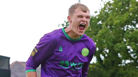 Caernarfon Town goalkeeper Ben Hughes celebrates