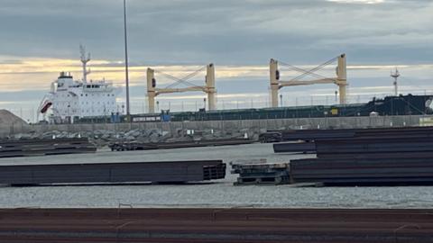 The MV Ruby ship docked in Great Yarmouth. The large cargo ship sits next to a docking station.