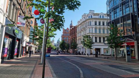 View of Royal Avenue in Belfast no cars on the road, people are walking on the footpath. 