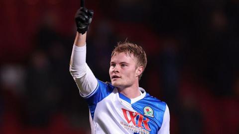Andri Gudjohnsen points his right hand into the air while in action for Blackburn Rovers