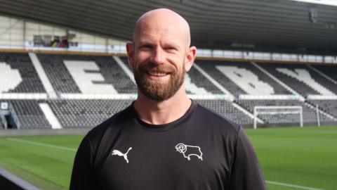 Chris Poole stood at Pride Park Stadium