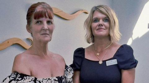 Mechelle Harris and Zoe Draper from The Hummingbird Centre. They are both wearing dresses and looking at the camera.