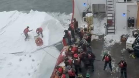 Coast Guard cutter rescues snowmobiler stranded on ice.