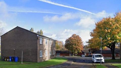 Two storey flat on Walmsley Close on a sunny day with autumnal leaves on the trees and white van parked nearby