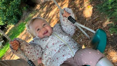 One-year-old Ottilie on a swing