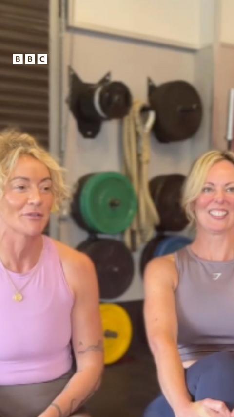 Two women sat next to each other.