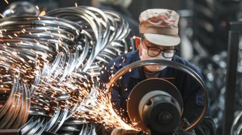 An employee polishes bicycle steel rings for export at a foreign trade enterprise on February 26, 2025 in Tianmushan Town, Hangzhou City, Zhejiang Province of China.