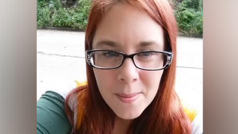 Aimee Betro, in a selfie taken from social media, with long straight hair and wide glasses. She is squinting slightly at the camera.