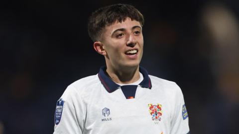 Sam Taylor, wearing Tranmere's white shirt with a navy blue collar, during an EFL Trophy game against Stockport in November 2024