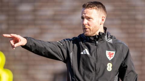 Chris Gunter points during a training session