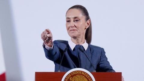 Mexican President Claudia Sheinbaum points out to the audience from her podium