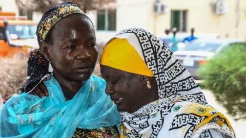 Two women console each other following the spate of suicide bomb attacks