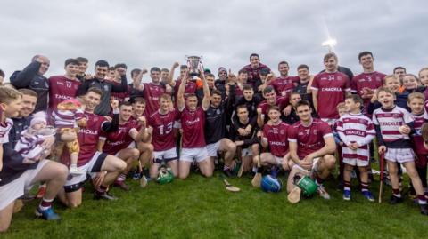 Slaughtneil players celebrate with the cup