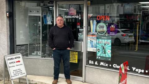 A man outside a shop