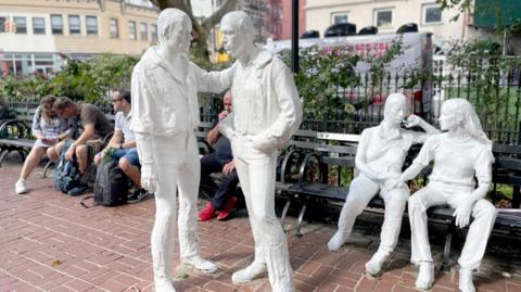 Stonewall National Monument located in Christopher Street Park in Greenwich Village, New York City, across the street from the Stonewall Inn, was the site of the Stonewall Rebellion and the LGBTQ+ rights movement. The figures crafted by artist George Segal from white bronze portray same-sex couples represent the LGBTQ+ community's fight for equality and freedom.