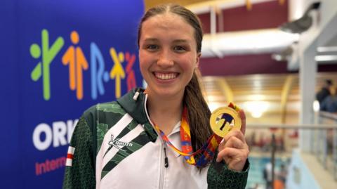 Chloe Bown poses with a medal