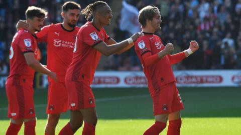 Leyton Orient players celebrate with Dom Ballard