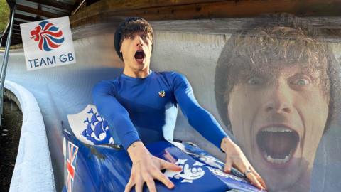Joel rushes down a bobsleigh race track.