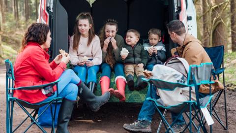 A family of six having a picnic