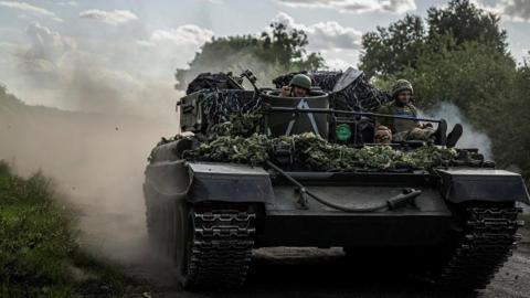 Ukrainian servicemen ride a military vehicle, amid Russia's attack on Ukraine, near the Russian border in Sumy region, Ukraine August 11, 2024. 