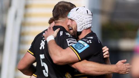 Harrison Keddie of Dragons celebrates scoring a try with team mates