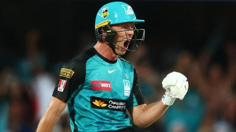 Nathan McSweeney celebrates guiding Brisbane Heat to a win over Adelaide Strikers in the Big Bash