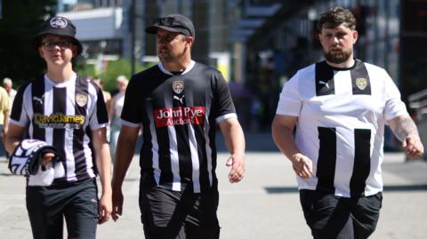 Notts County fans walk towards Wembley before the League Two play-off final against Salford City
