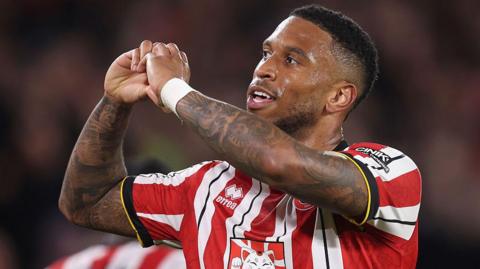 Tyrese Campbell makes a heart gesture with his hands